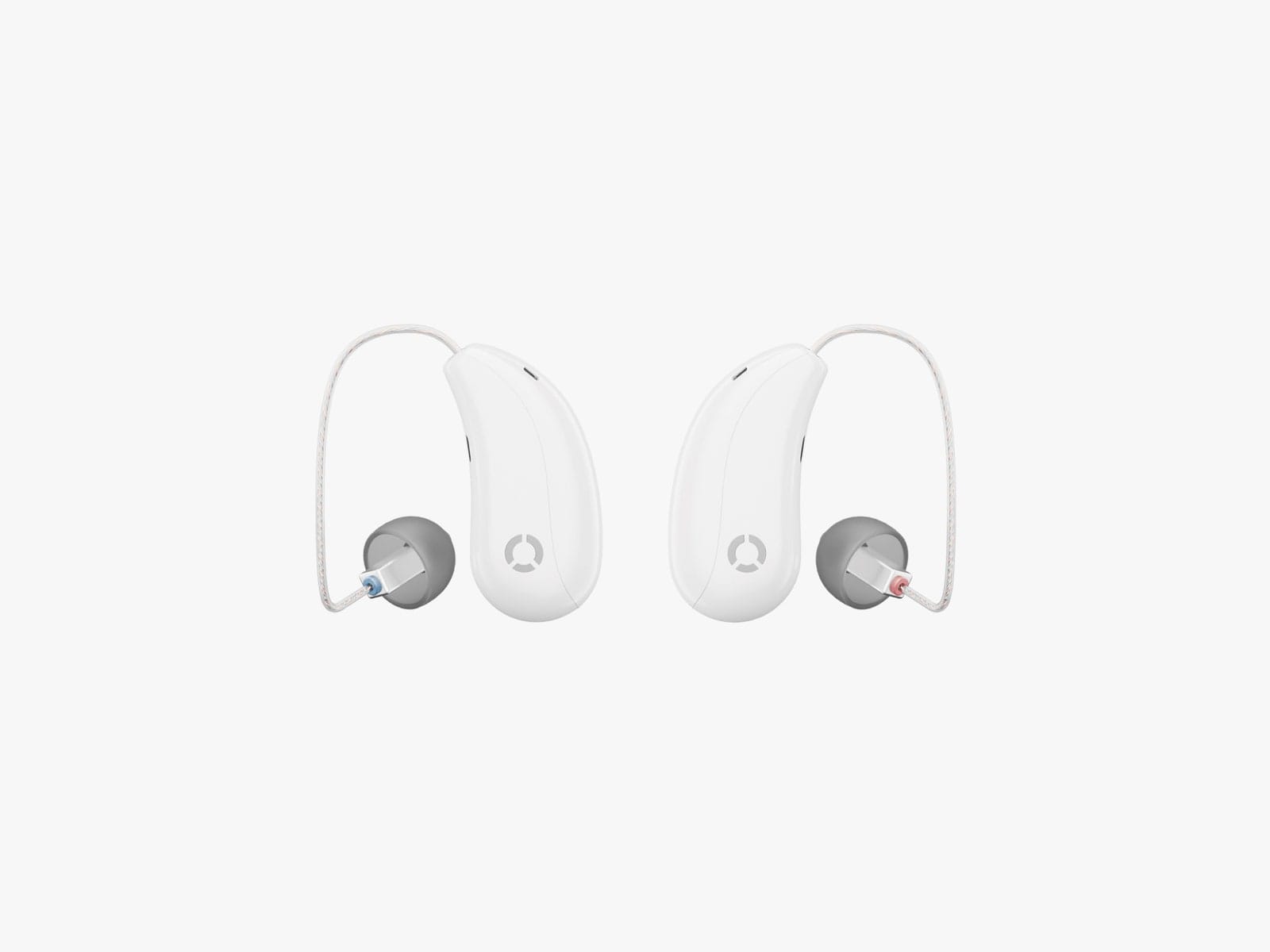 Two side by side white overtheear hearing aids with grey ear canal cushions